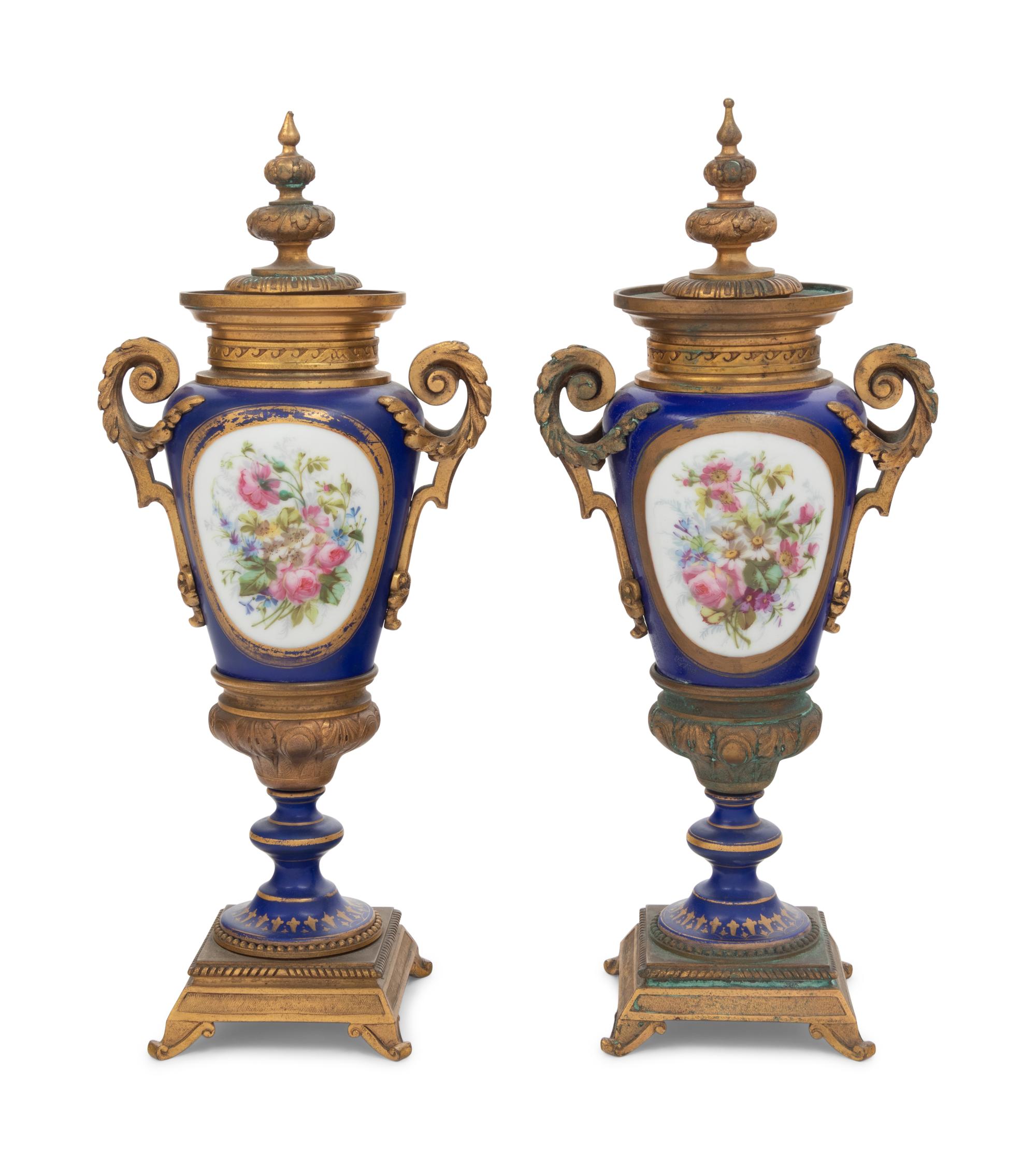A Pair of Sèvres Style Gilt Bronze Mounted Porcelain Urns