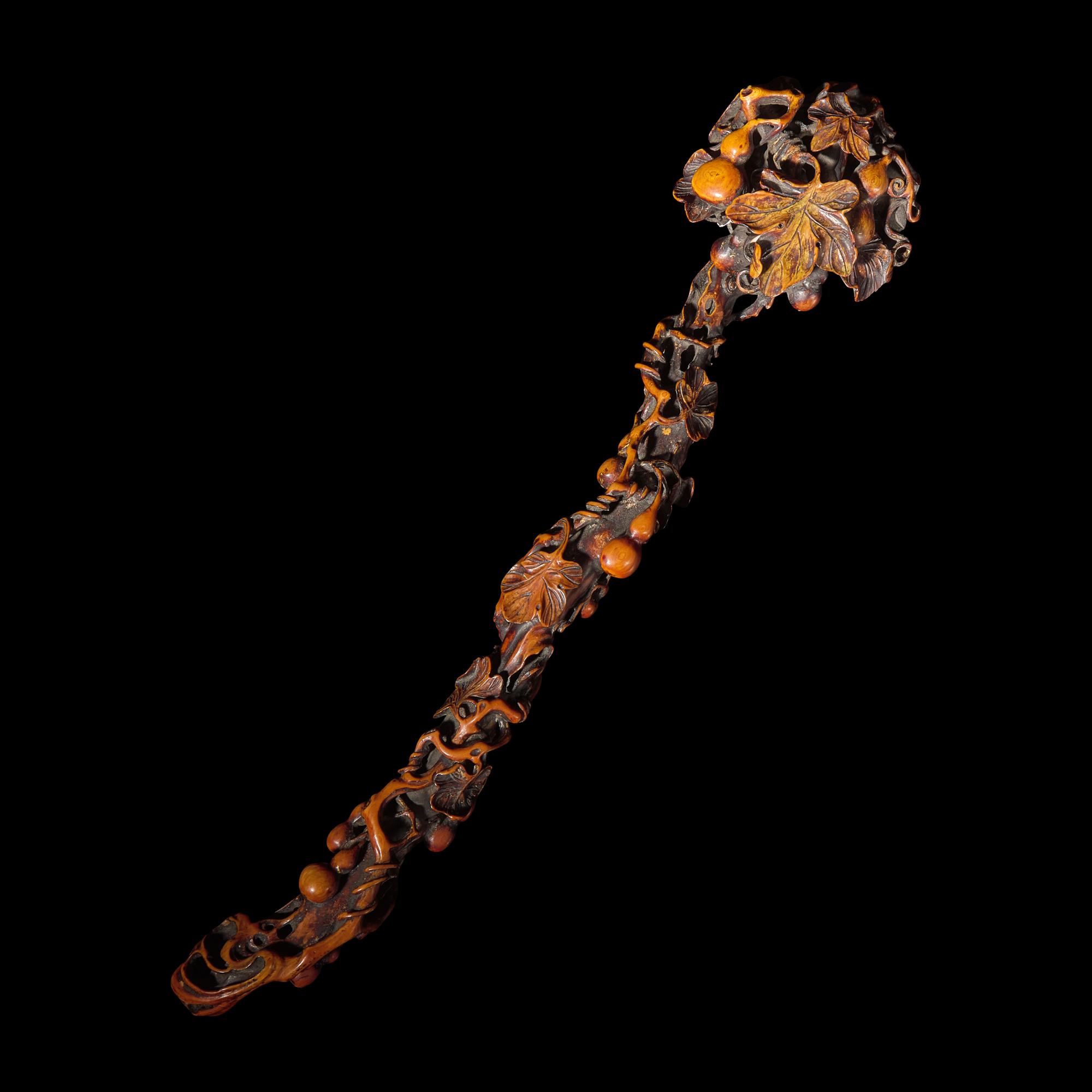 A Chinese Finely Carved Stained Bone Ruyi Scepter, Qing Dynasty — 清 木“福祿萬代”如意