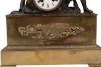 An Empire Style Gilt and Patinated Bronze Figural Mantel Clock