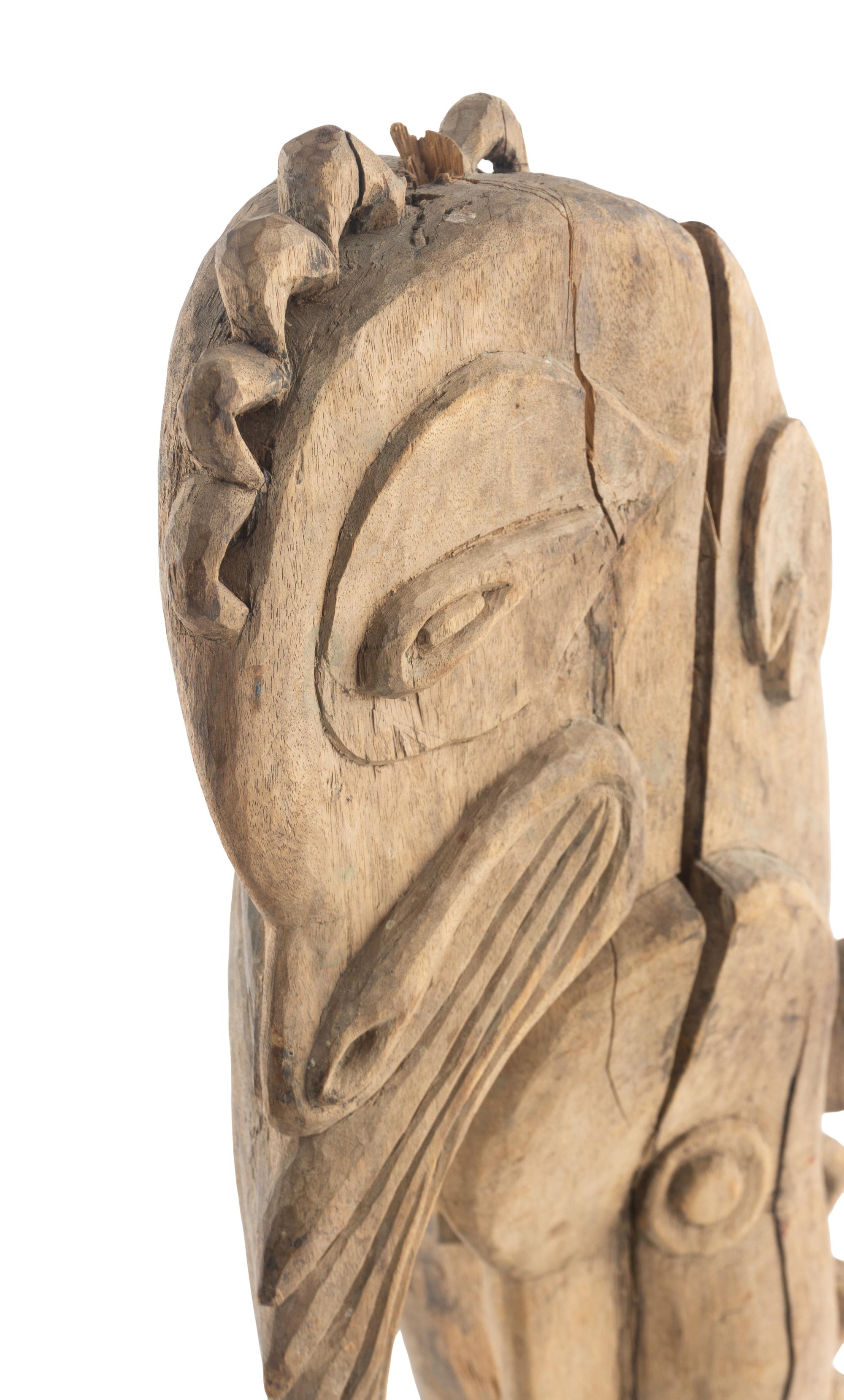 An African Wooden Figure with Bird Headdress