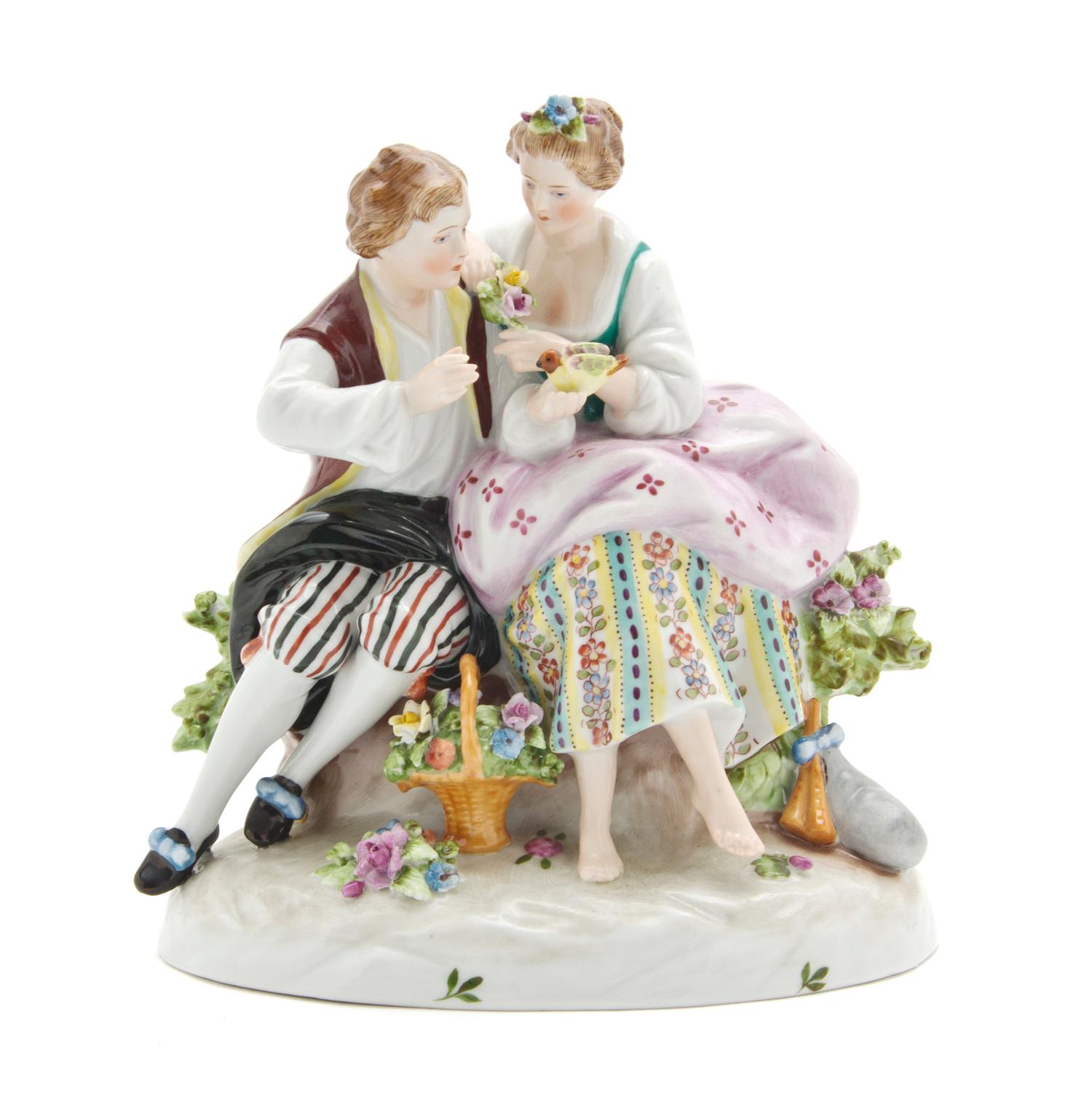 A Continental Porcelain Figural Group, Height 7 inches.