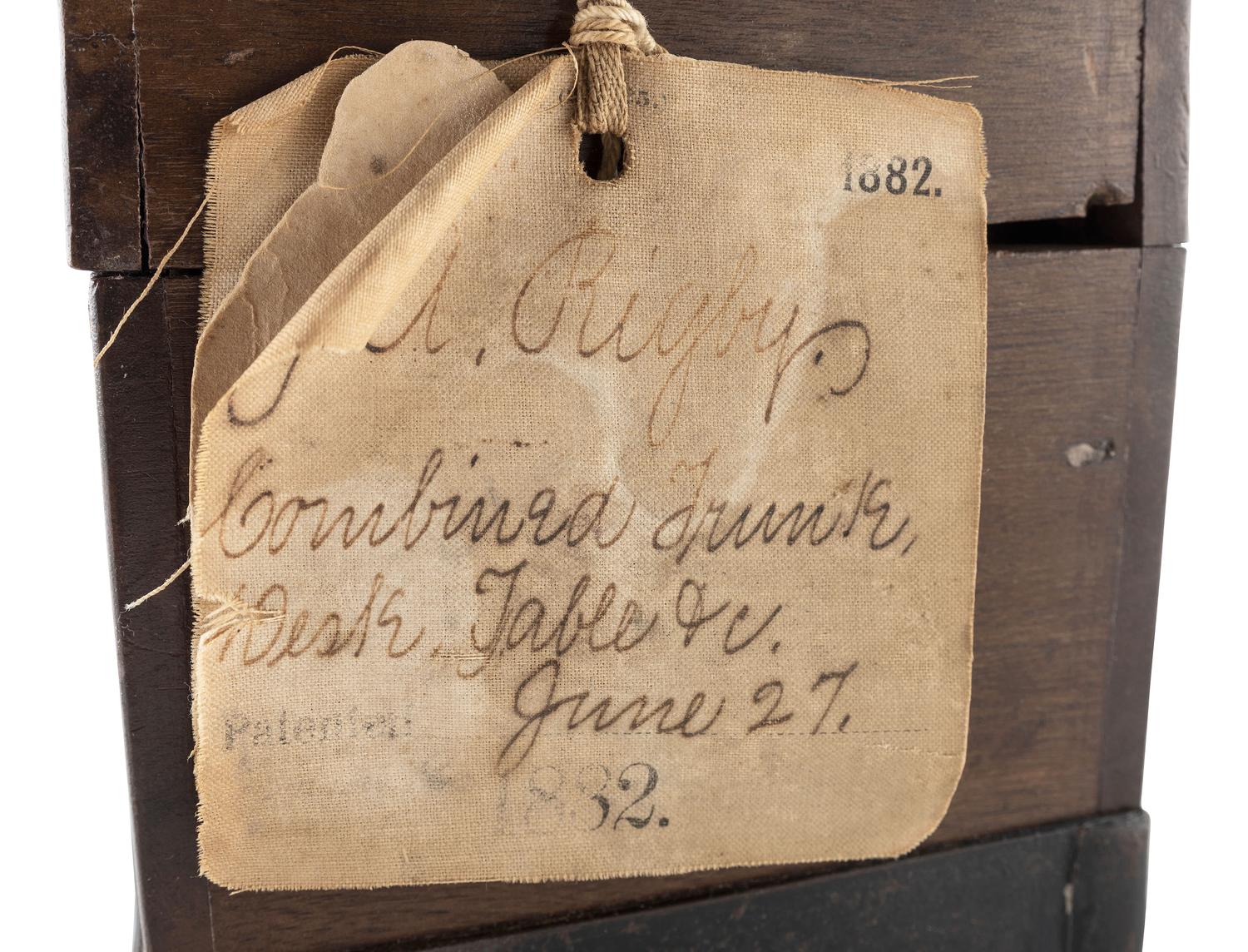 [SCIENCE & TECHNOLOGY]. James A. Rigby patent model for a "Combined Trunk, Desk, Table &c." with original tags, 1882.