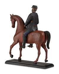 A Carved and Painted Wood Figure of a German Soldier on Horseback