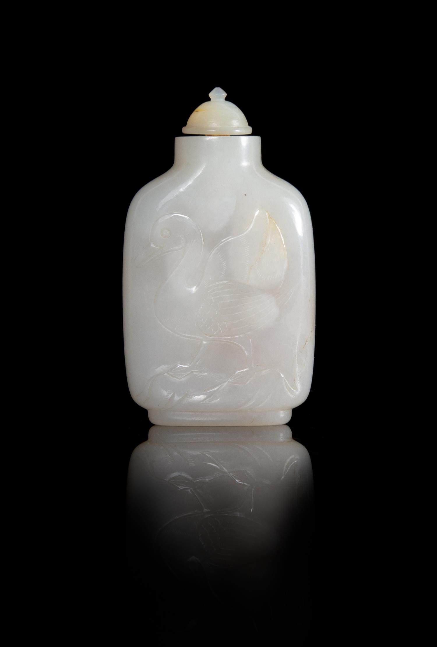A Carved White Jade Snuff Bottle Height 3 inches.