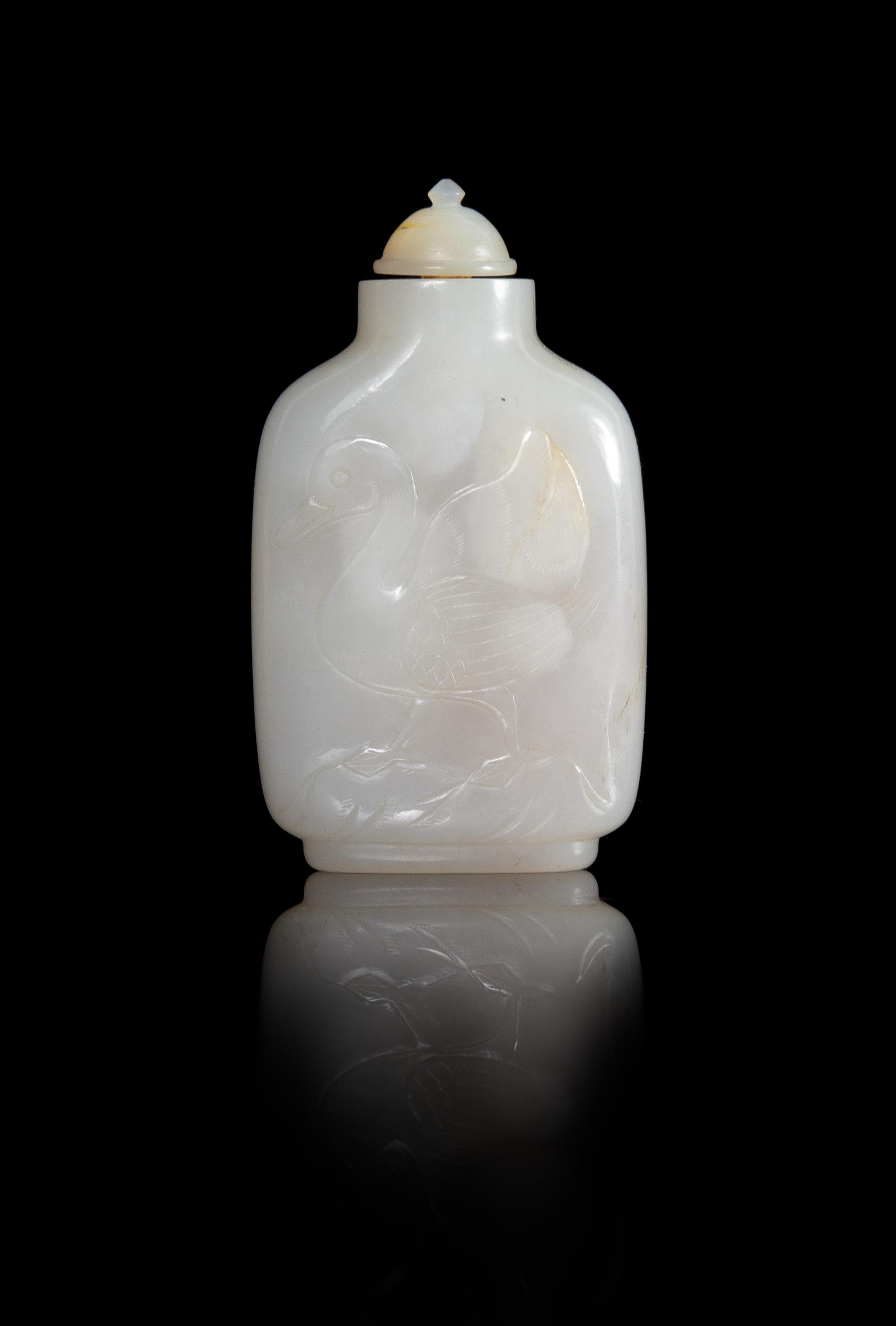 A Carved White Jade Snuff Bottle Height 3 inches.