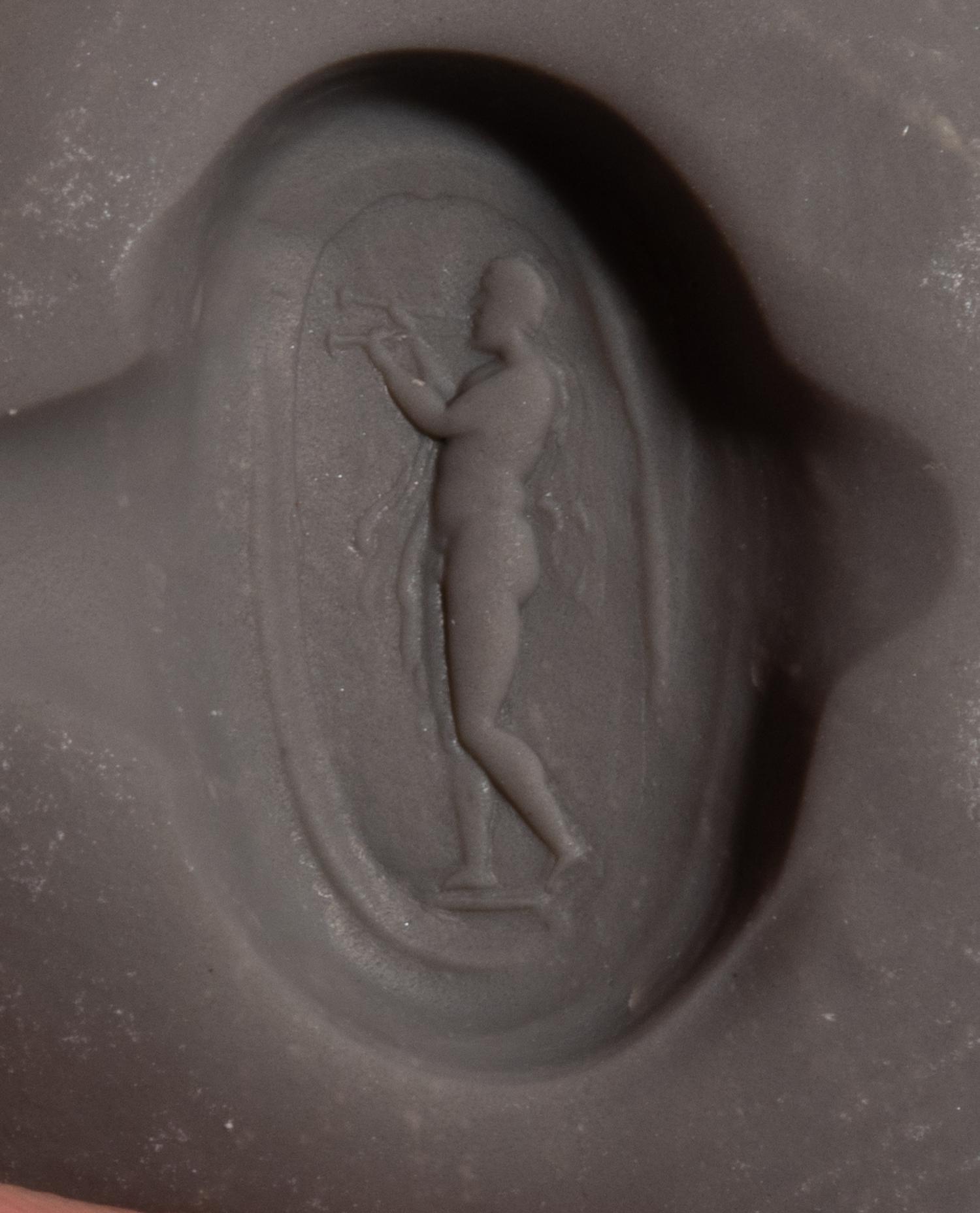 A Roman Carnelian Ring Stone with the God Silenus Playing an Aulos — Set in a gold ring