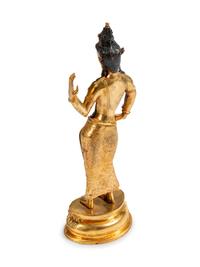 A Tibetan Jeweled Bronze and Sodalite Figure of a Deity