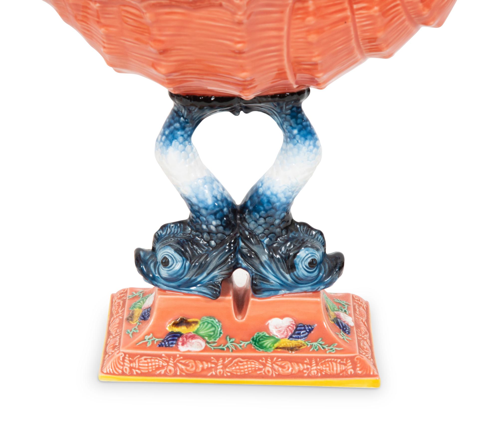 A Pair of Italian Glazed Ceramic Shell-form Compotes on Dolphin Supports