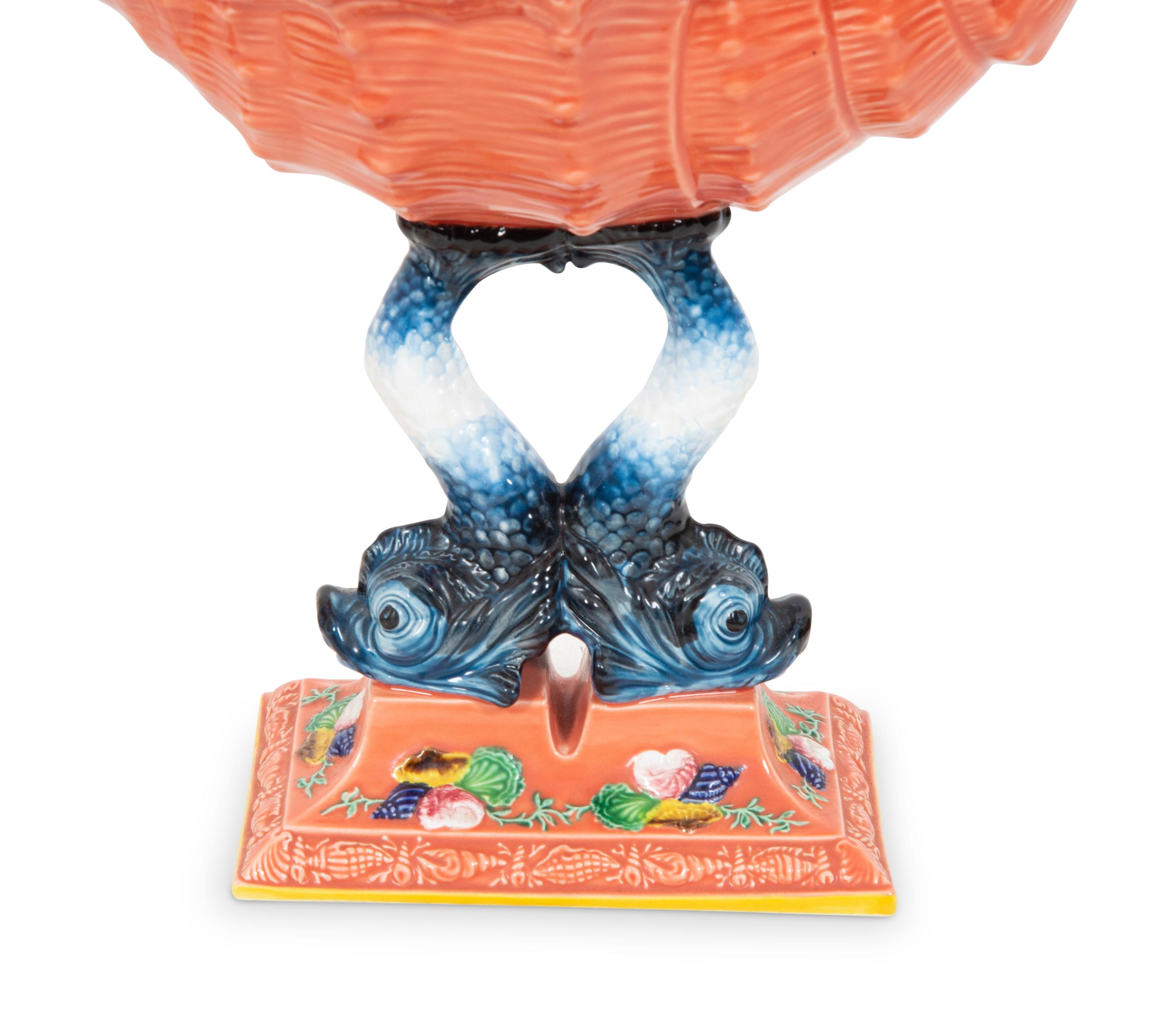 A Pair of Italian Glazed Ceramic Shell-form Compotes on Dolphin Supports