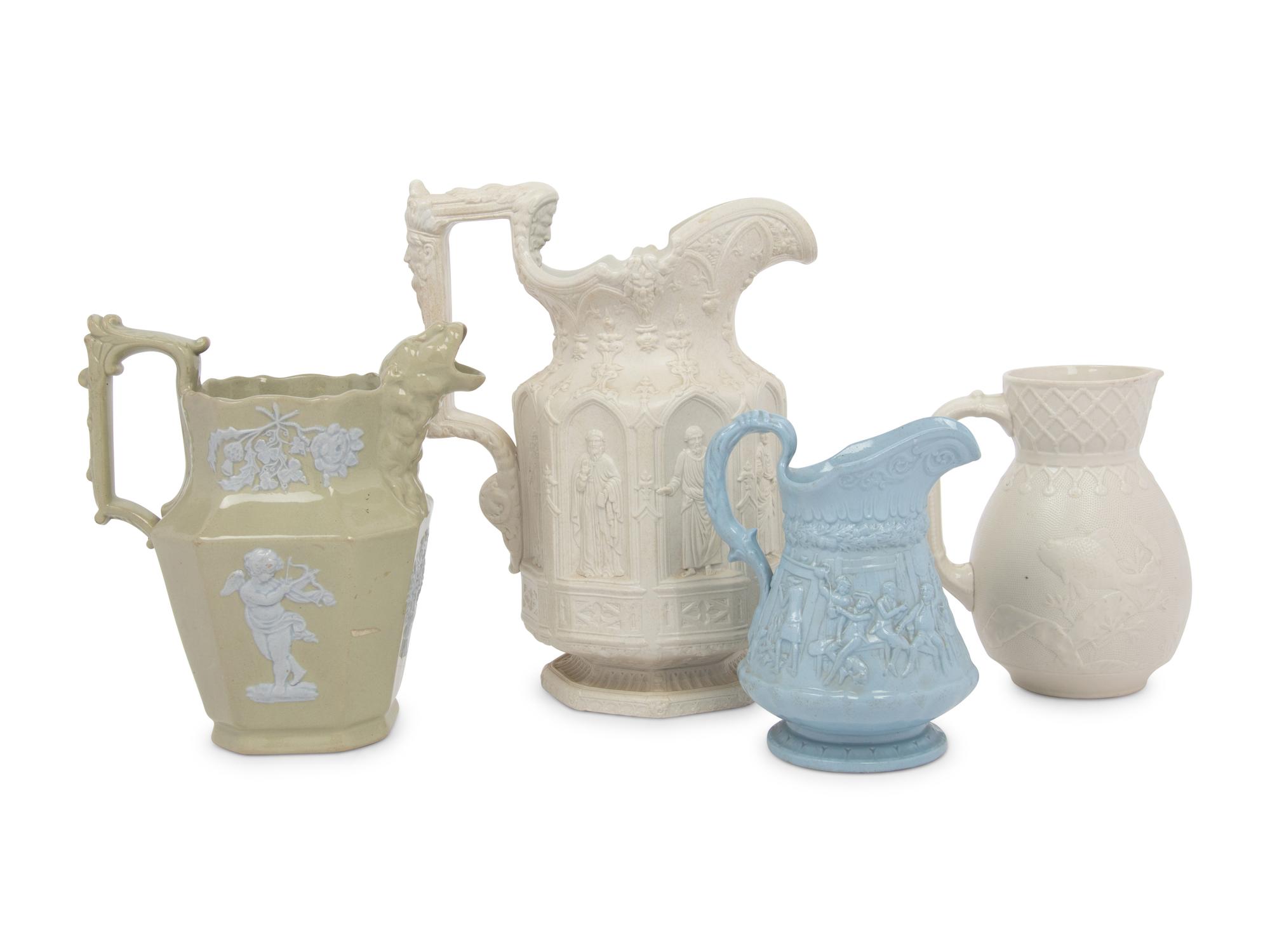 Four English Molded and Glazed Pottery Pitchers