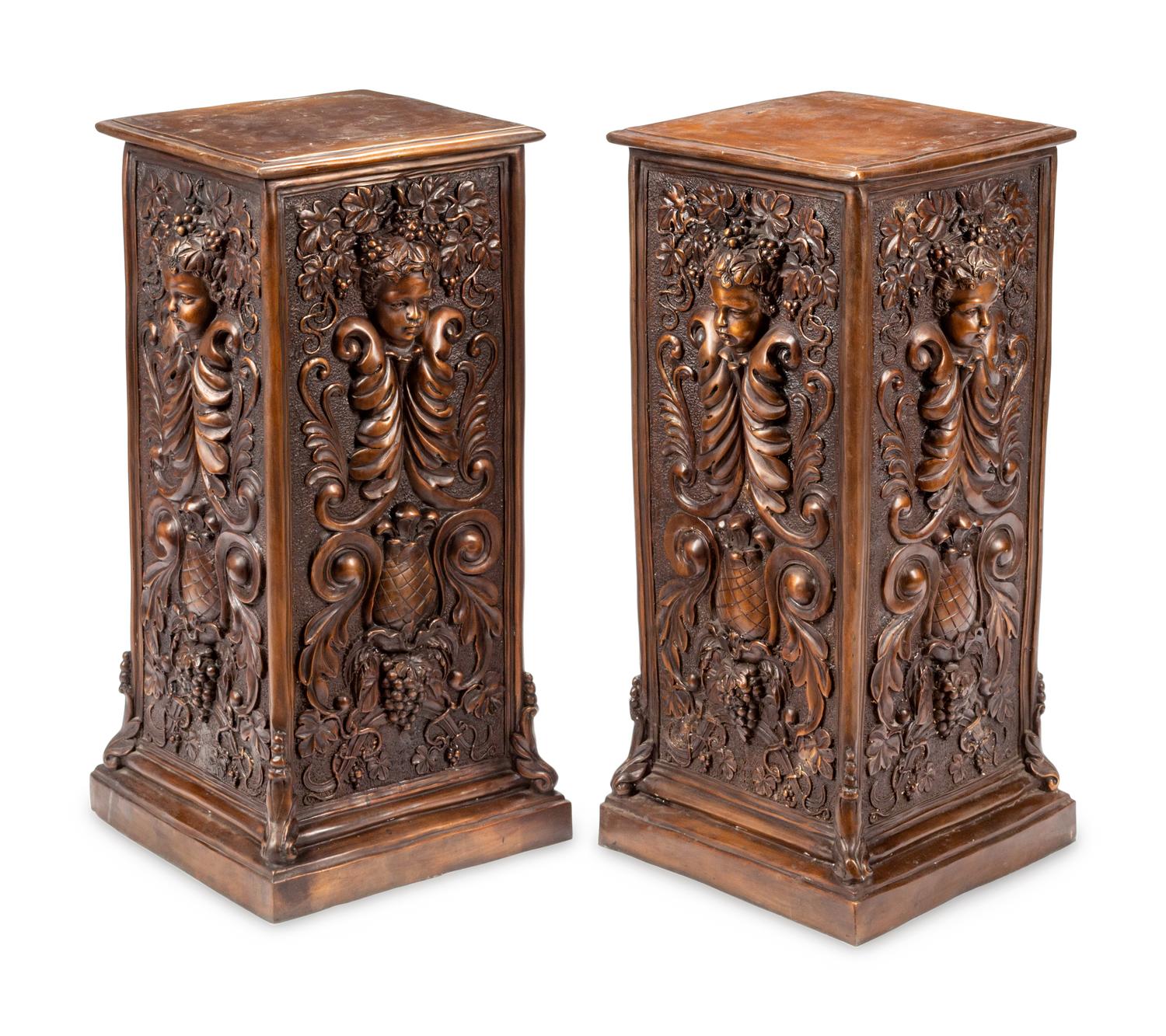 A Pair of Continental Patinated Bronze Pedestals with Cherub Masks