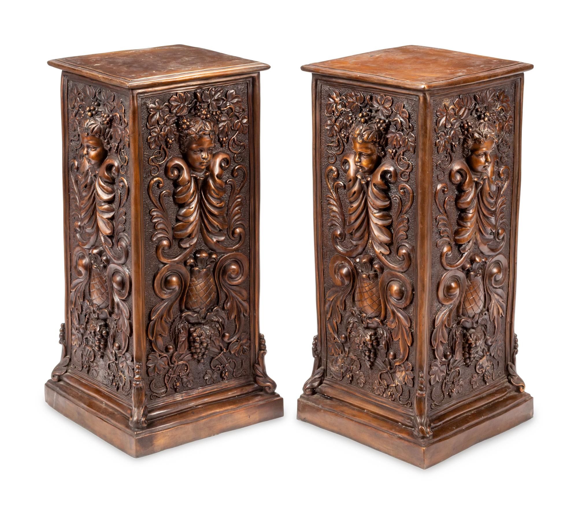 A Pair of Continental Patinated Bronze Pedestals with Cherub Masks