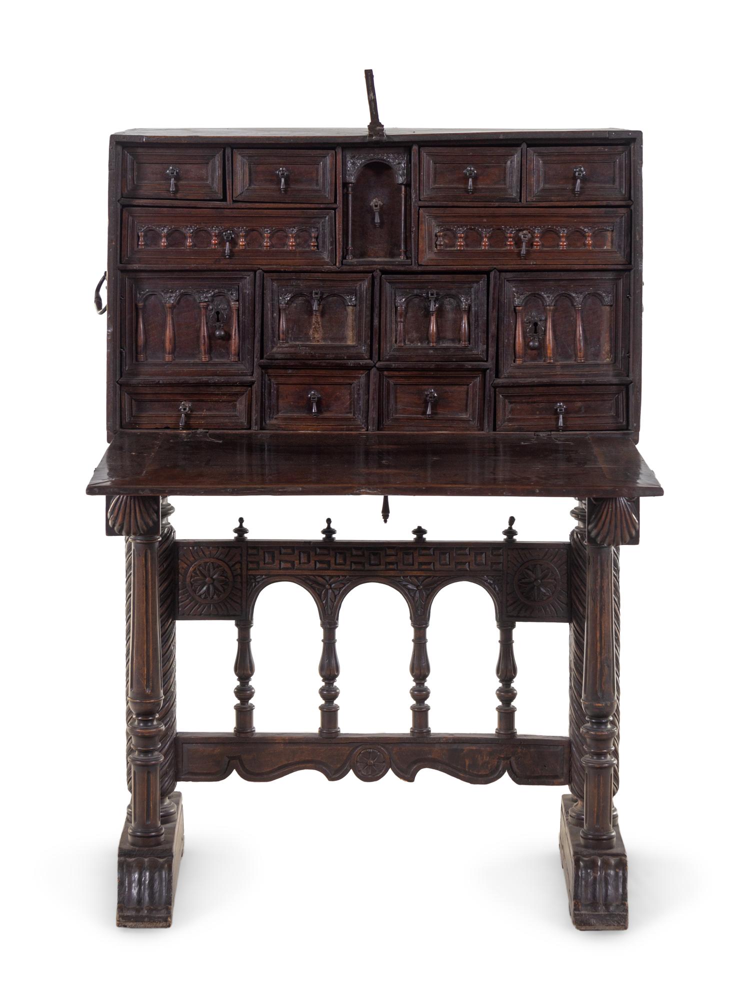 A Spanish Iron Mounted Carved Walnut Vargueño on Stand