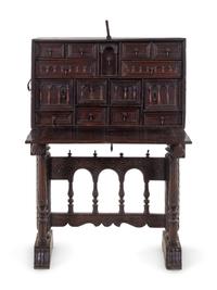 A Spanish Iron Mounted Carved Walnut Vargueño on Stand