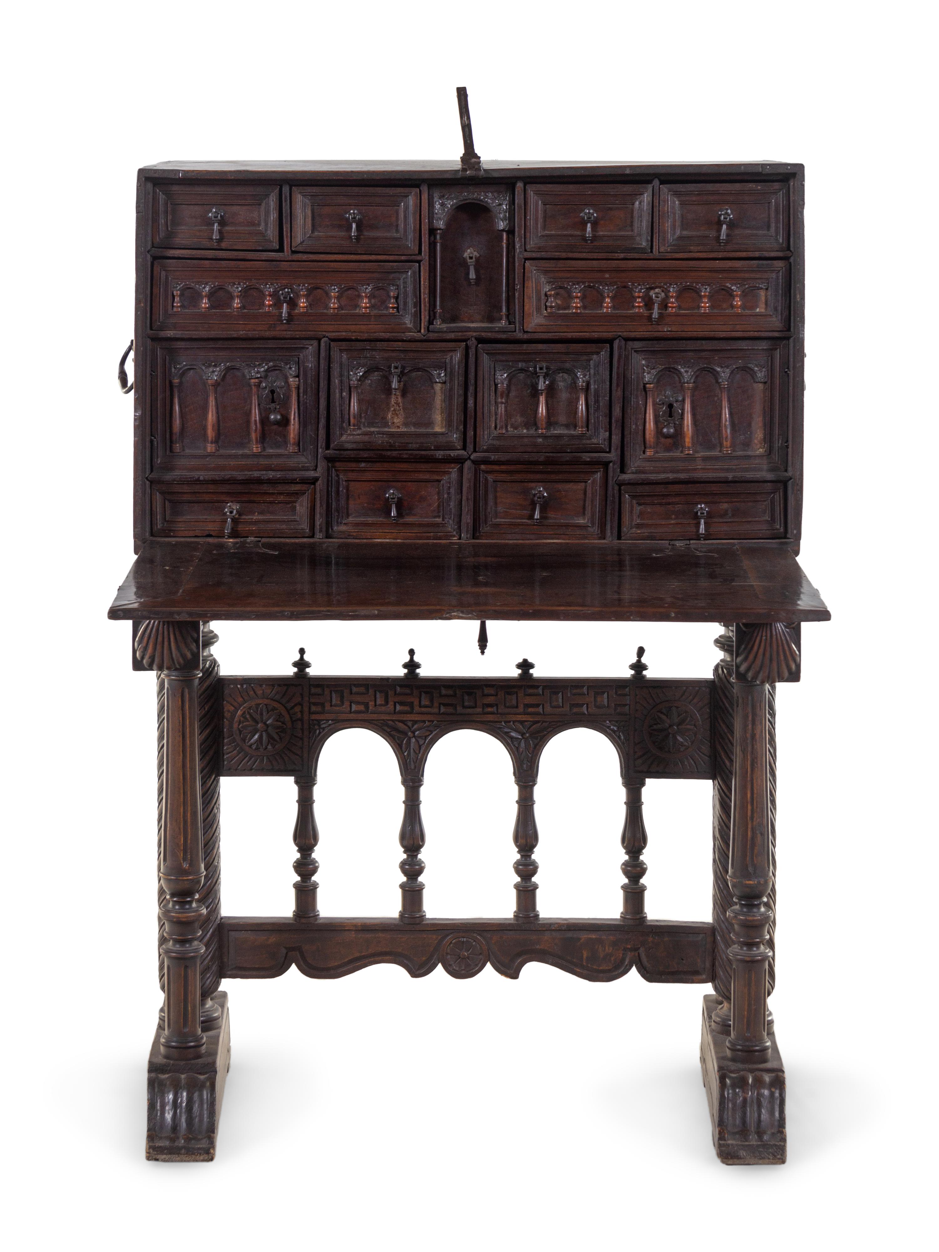 A Spanish Iron Mounted Carved Walnut Vargueño on Stand