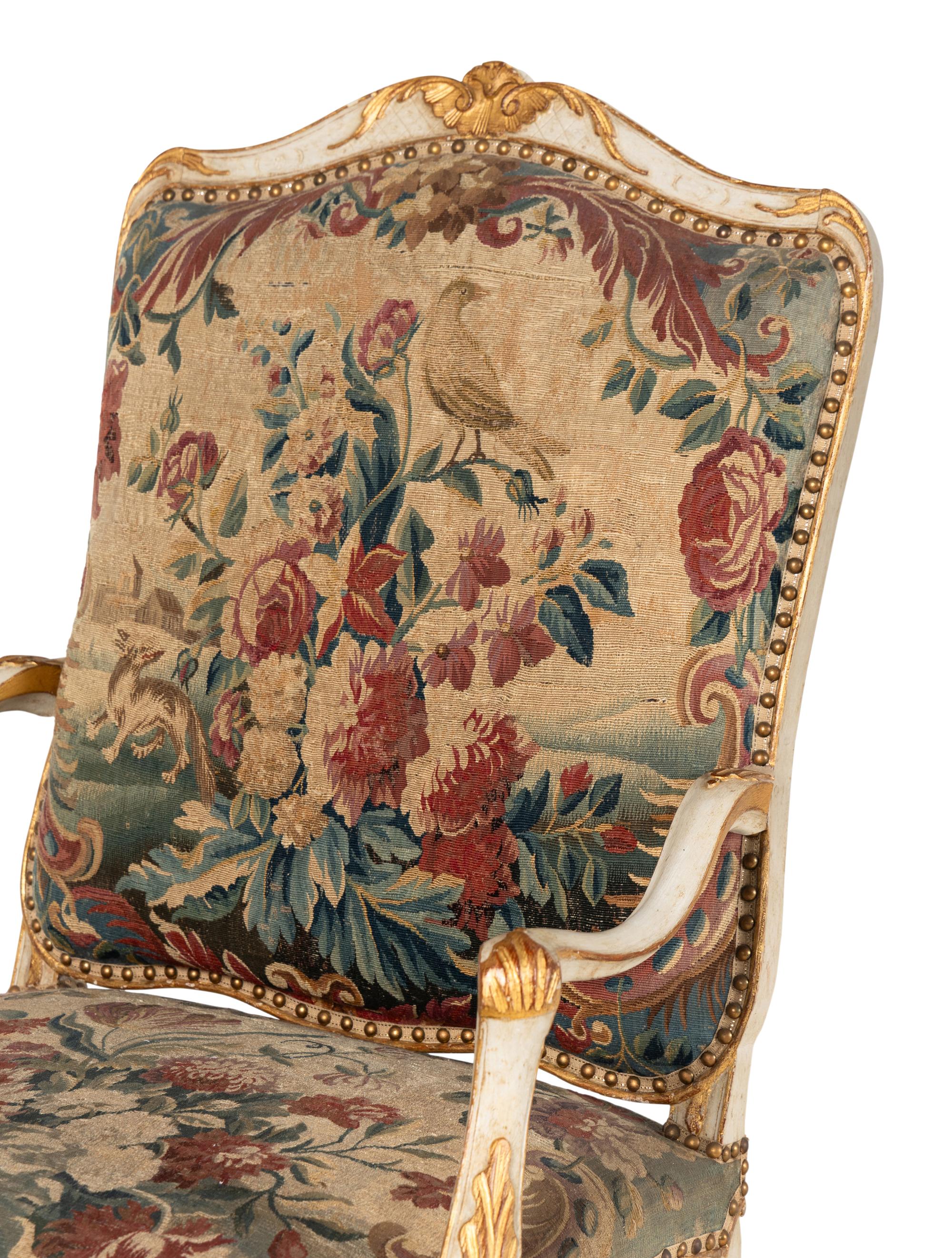 A Set of Four Louis XV White-Painted and Parcel Gilt Tapestry-Upholstered Fauteuils