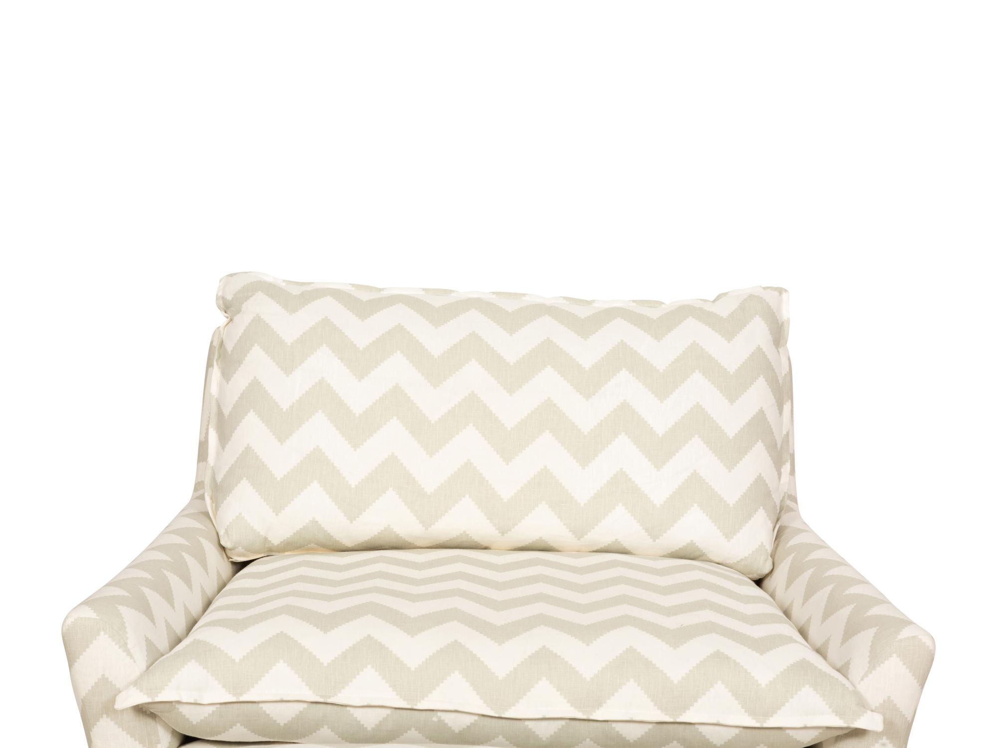 A Contemporary Upholstered Armchair and Ottoman