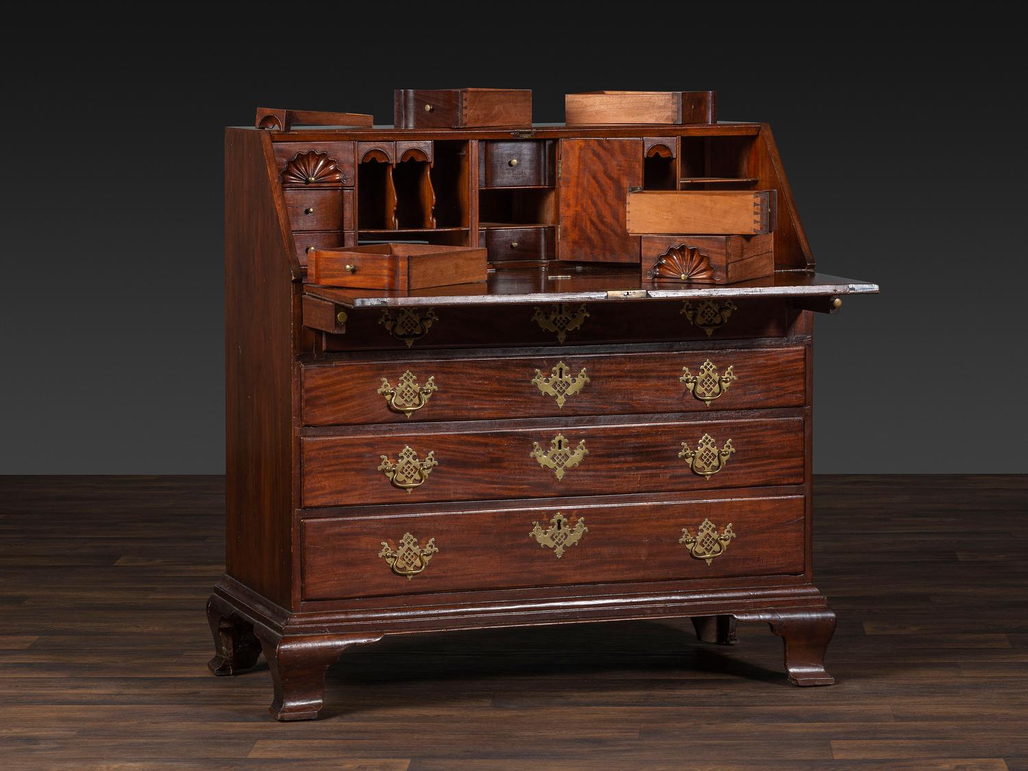 A Chippendale Figured and Shell-Carved Mahogany Slant Front Desk