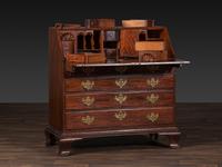 A Chippendale Figured and Shell-Carved Mahogany Slant Front Desk