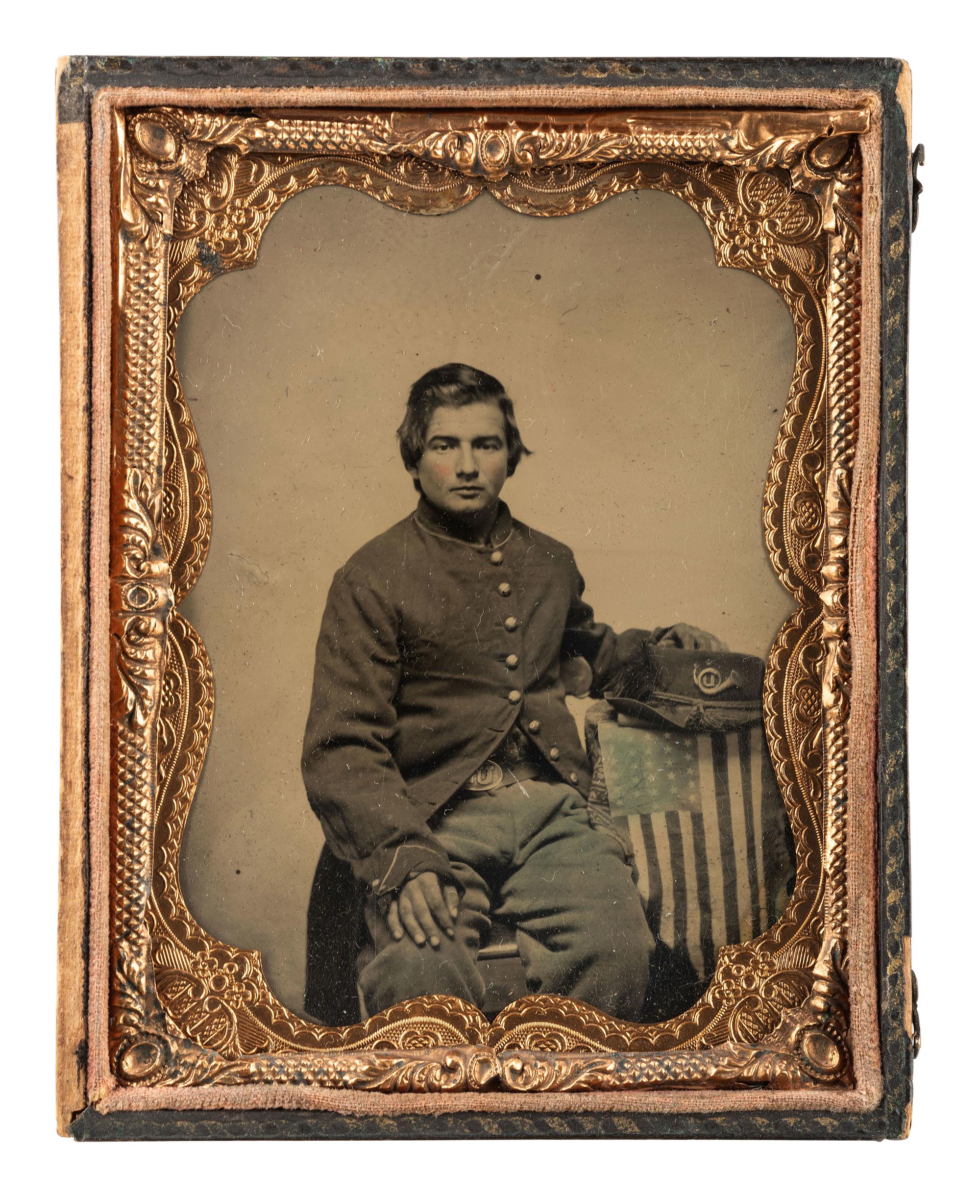 [CIVIL WAR]. A group of 4 items, highlighted by a quarter plate tintype of a Union infantryman posed with an American flag attributed as Joseph Graff, Company D, 23rd Kentucky Infantry.