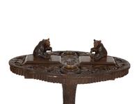 A Swiss Black Forest Carved Wood Smoking Table