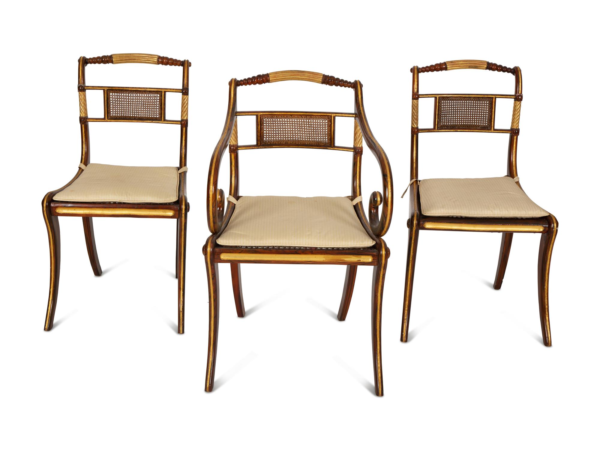 A Set of Fourteen Regency and Regency Style Rosewood and Parcel Gilt Dining Chairs