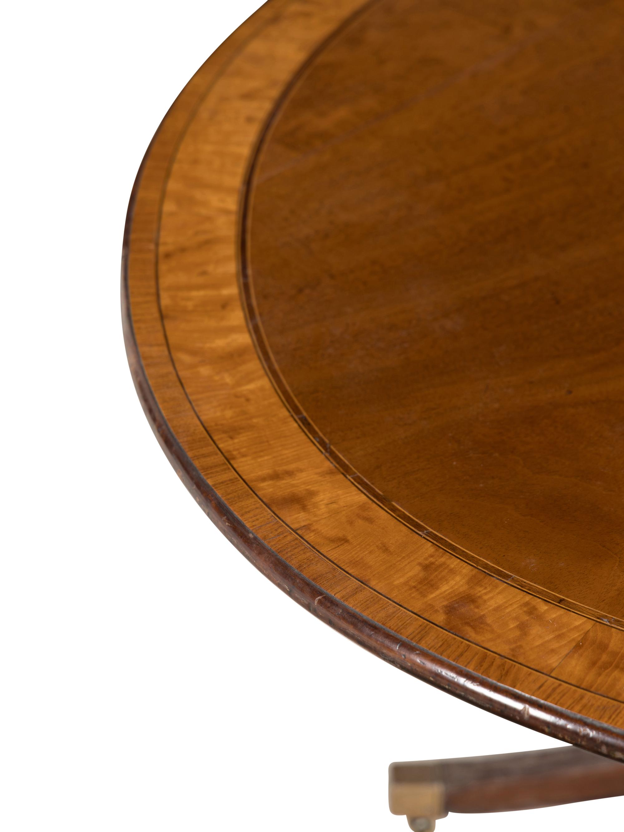 A Regency Mahogany and Satinwood Tilt-Top Breakfast Table