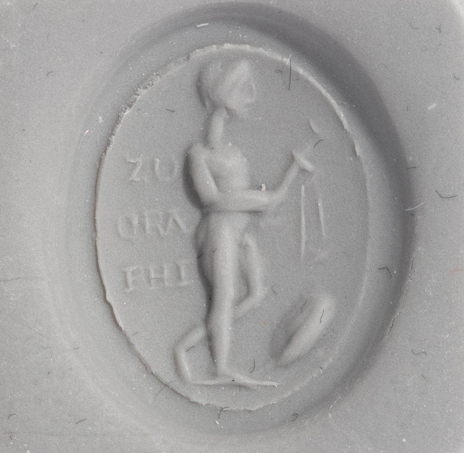 A Roman Gold and Plasma Finger Ring with a Figure Holding Tools and an Inscription