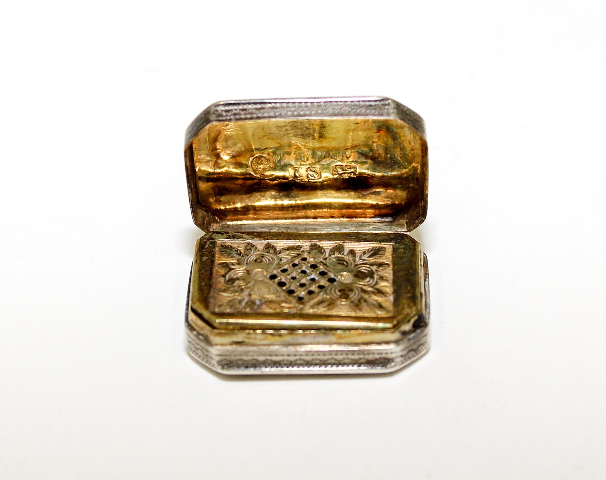 A George III Silver Vinaigrette, John Shaw, Birmingham, 1808, of rectangular form with canted corners, the lid and underside worked wit
