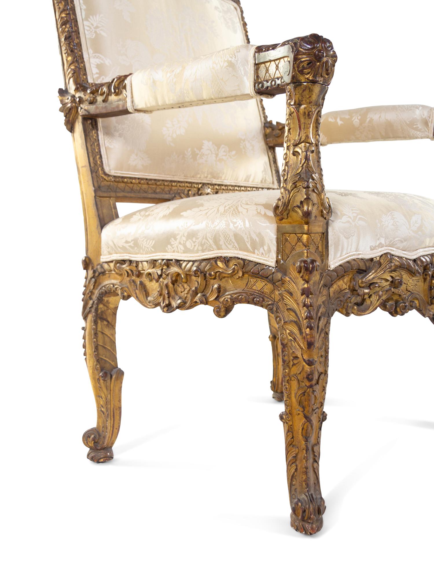 A Pair of Régence Style Carved Giltwood Fauteuils