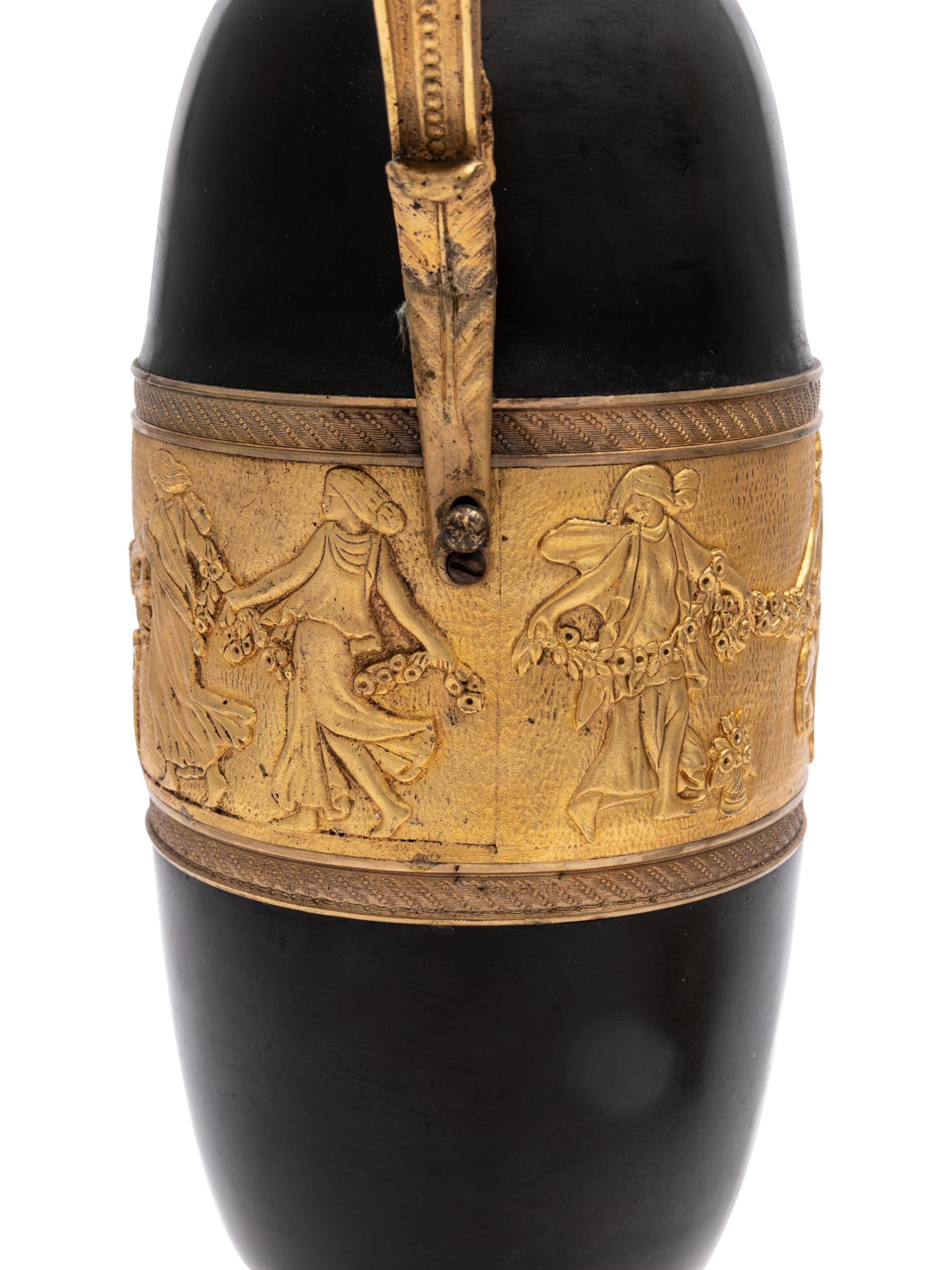 A Pair of Continental Gilt and Patinated Bronze Ewers