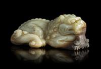 A Carved Celadon Jade Figure of a Recumbent Lion Length 4 3/4 inches.