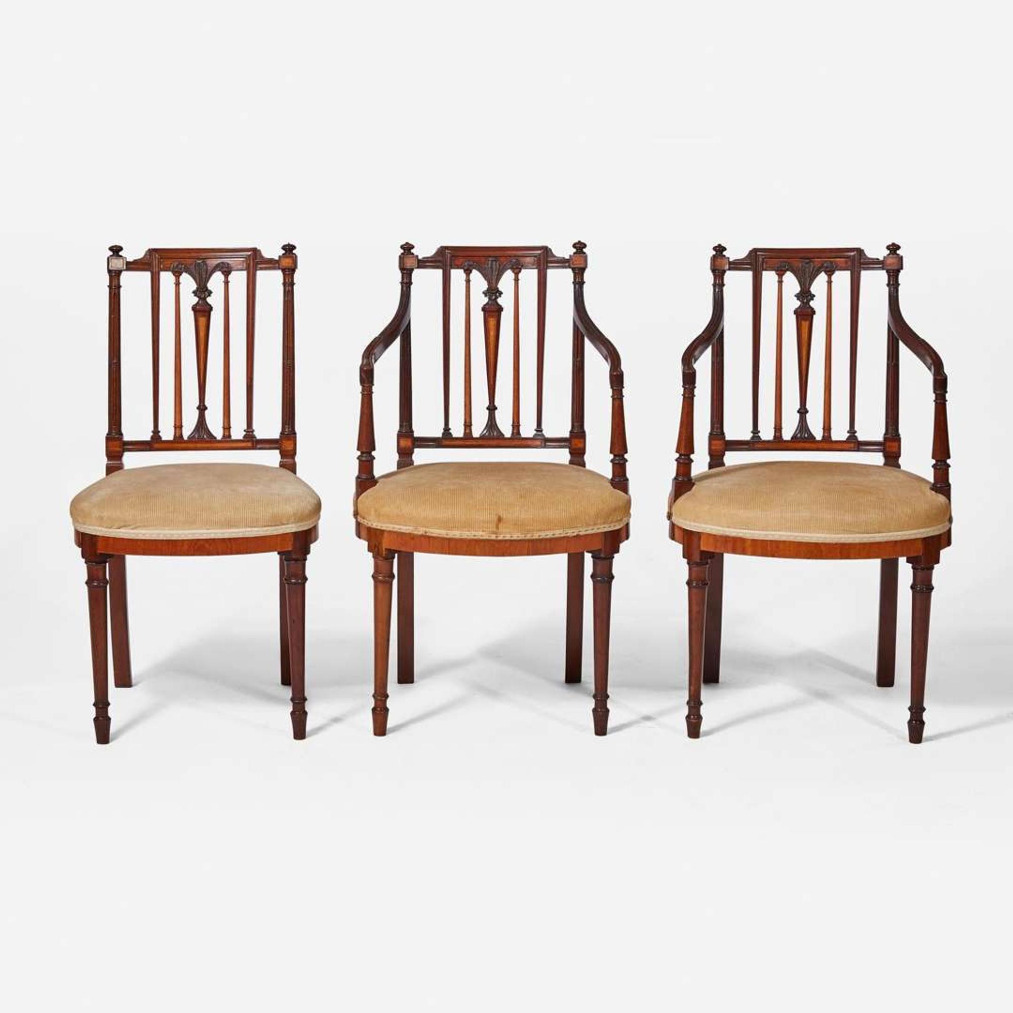 A group of three George III inlaid mahogany and satinwood dining chairs circa 1790