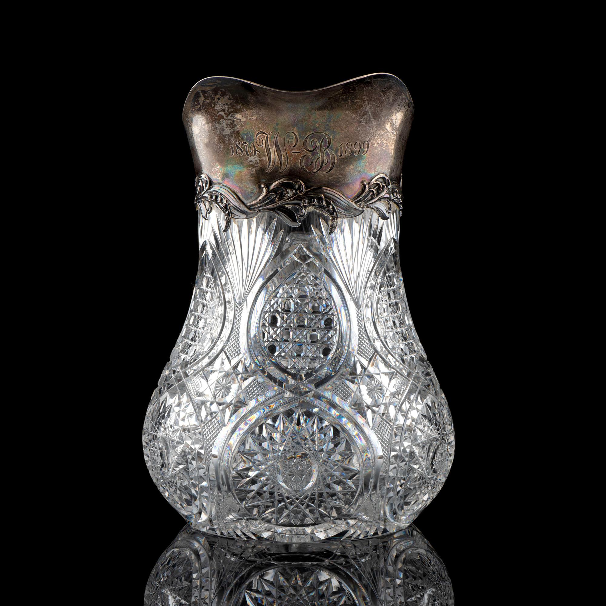 A Brilliant-Period Cut Glass Water Pitcher with Lilies of the Valley and a Silver Mount