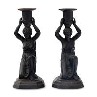 A Pair of Grand Tour Patinated Metal Figural Candlesticks