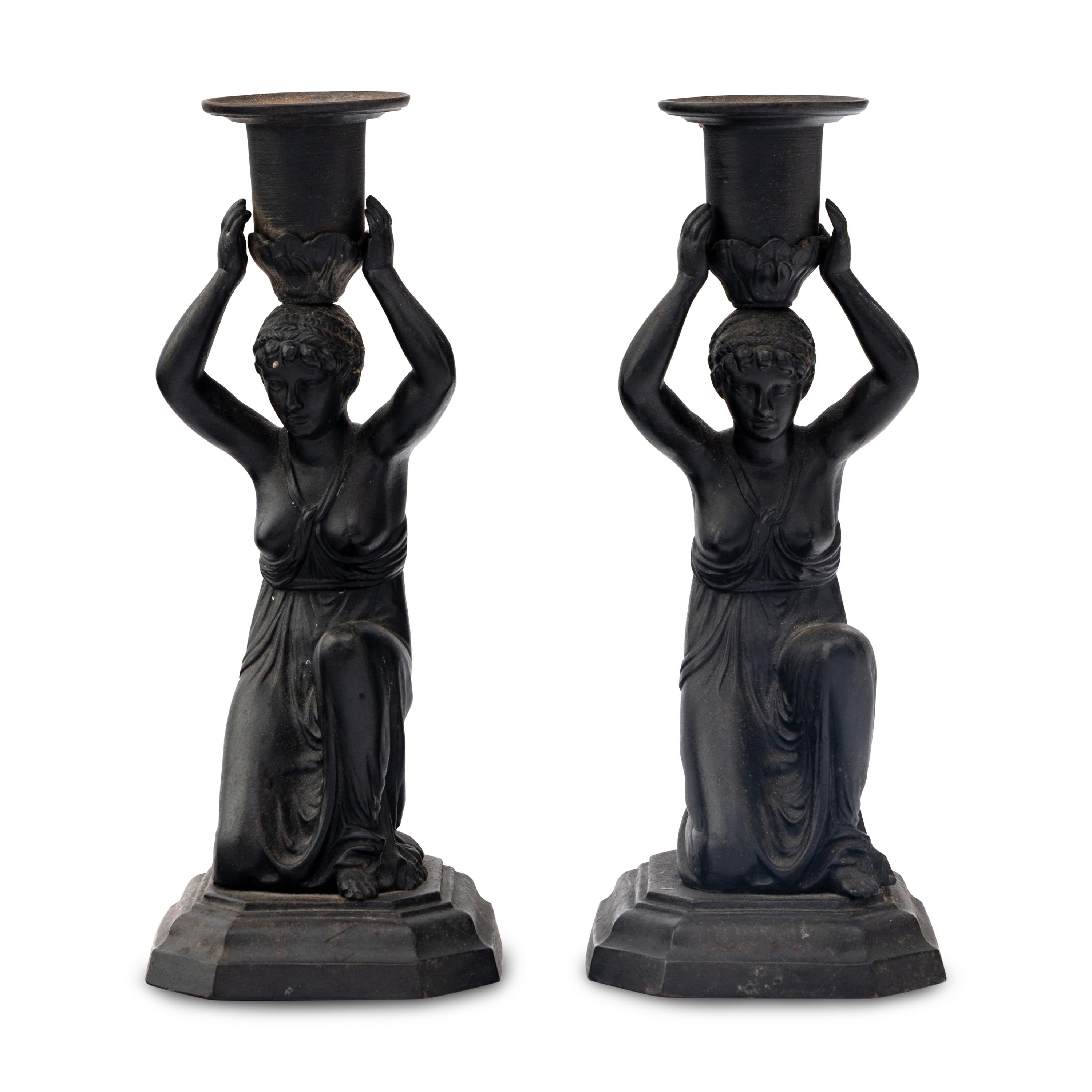 A Pair of Grand Tour Patinated Metal Figural Candlesticks