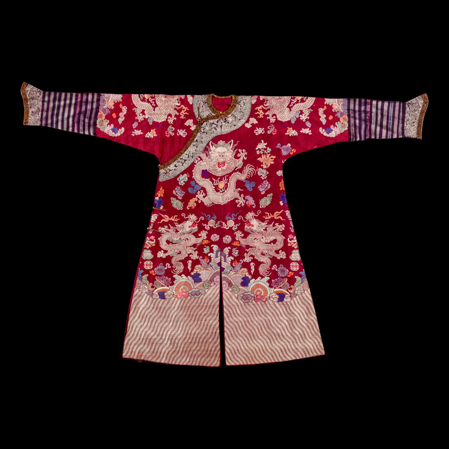 A Chinese Maroon Ground Silk Brocade 'Dragon' Robe, Jifu, Late Qing Dynasty 清晚期 絳紅地織錦龍紋吉服