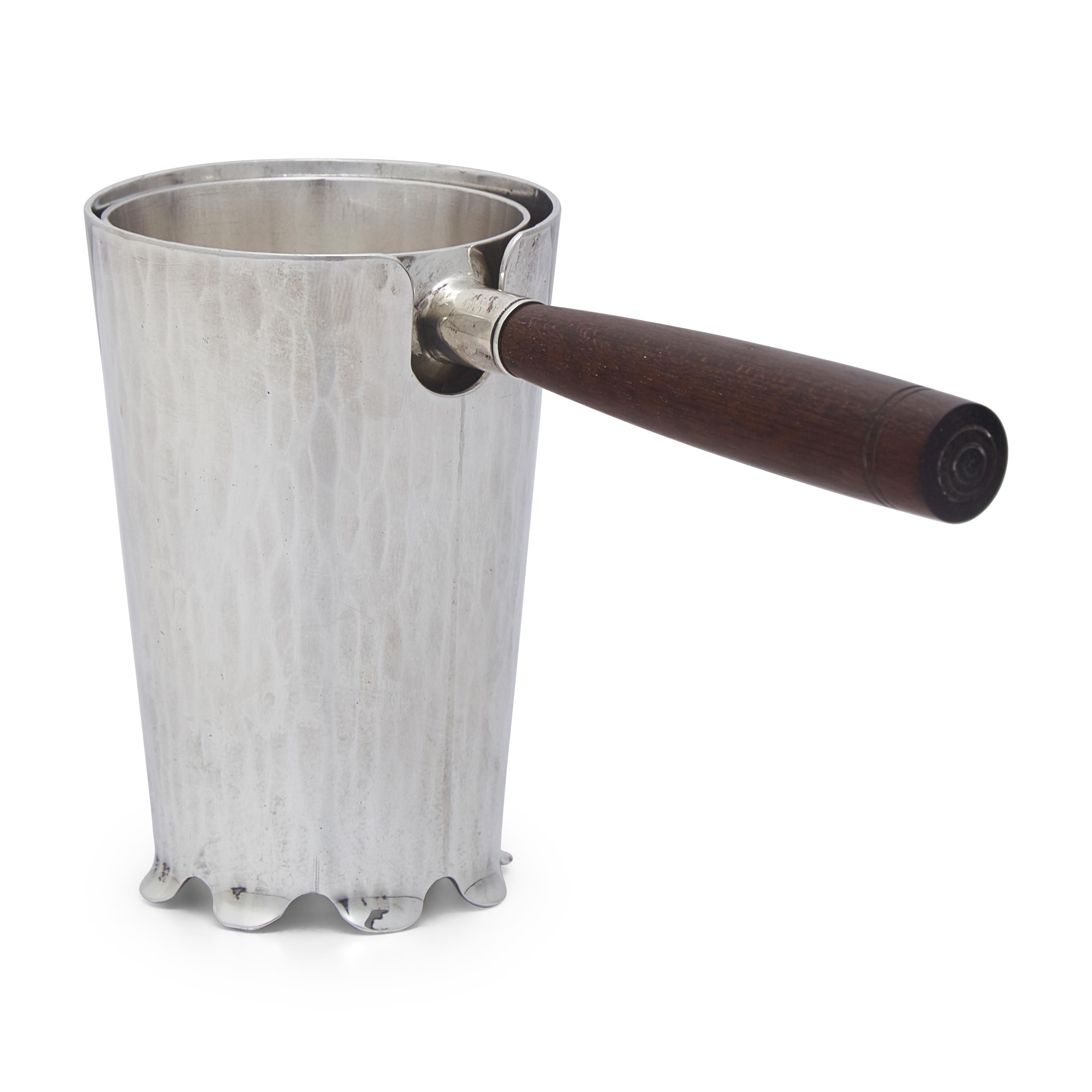 An Arts and Crafts Sterling Silver Tea Strainer and Stand