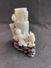 A Chinese jade "Boys, Kylin and Phoenix" vase on carved wood stand 玉雕童子凤鸟花樽及底座