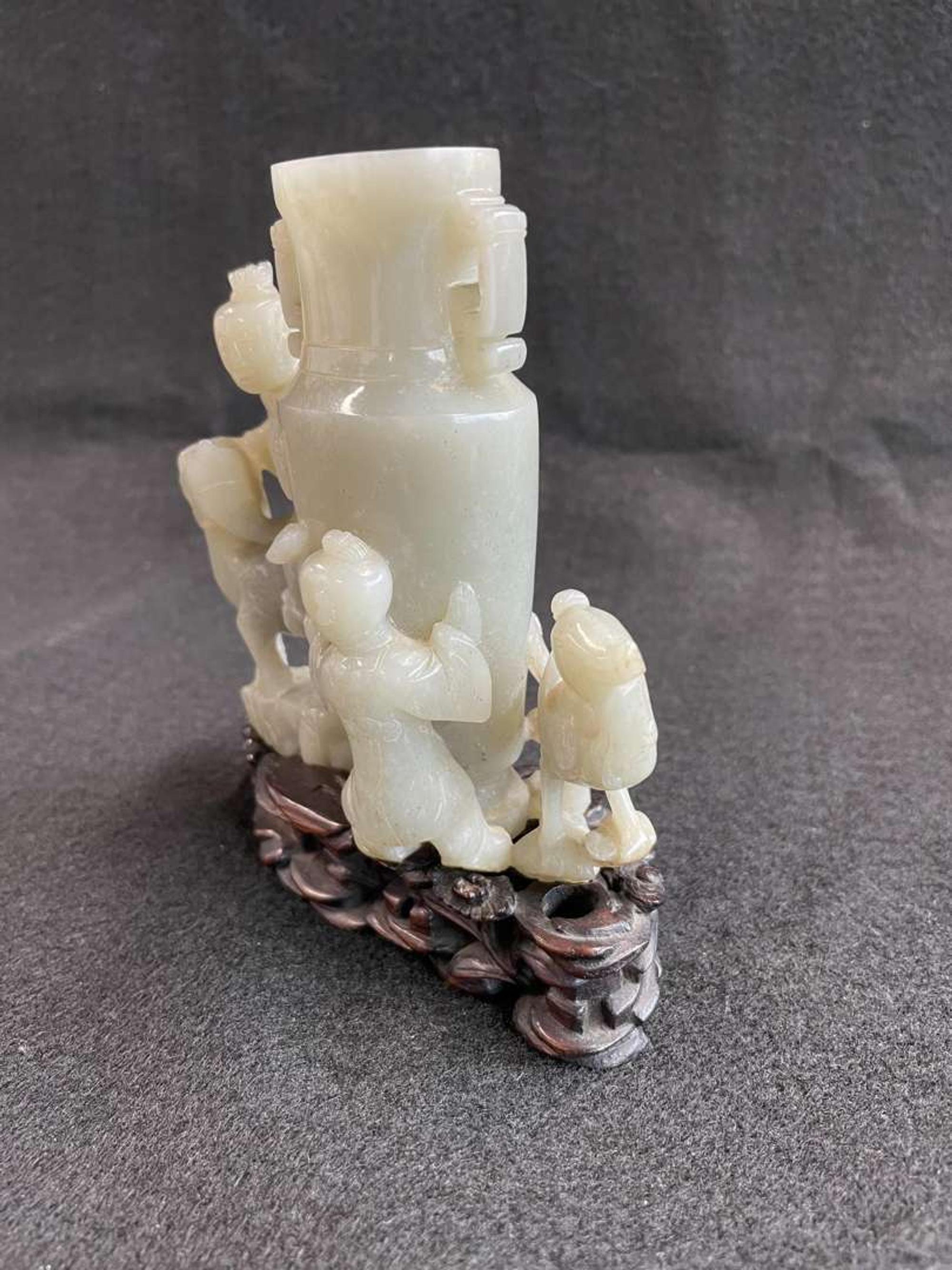 A Chinese jade "Boys, Kylin and Phoenix" vase on carved wood stand 玉雕童子凤鸟花樽及底座