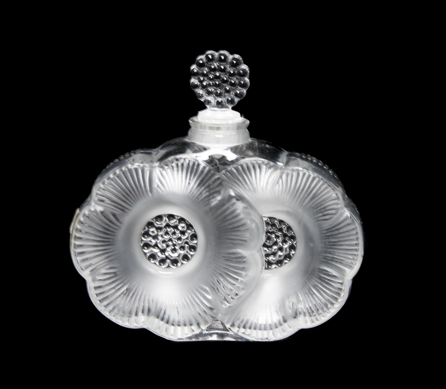 A Lalique Molded and Frosted Glass Perfume Bottle Height 3 3/4 inches.
