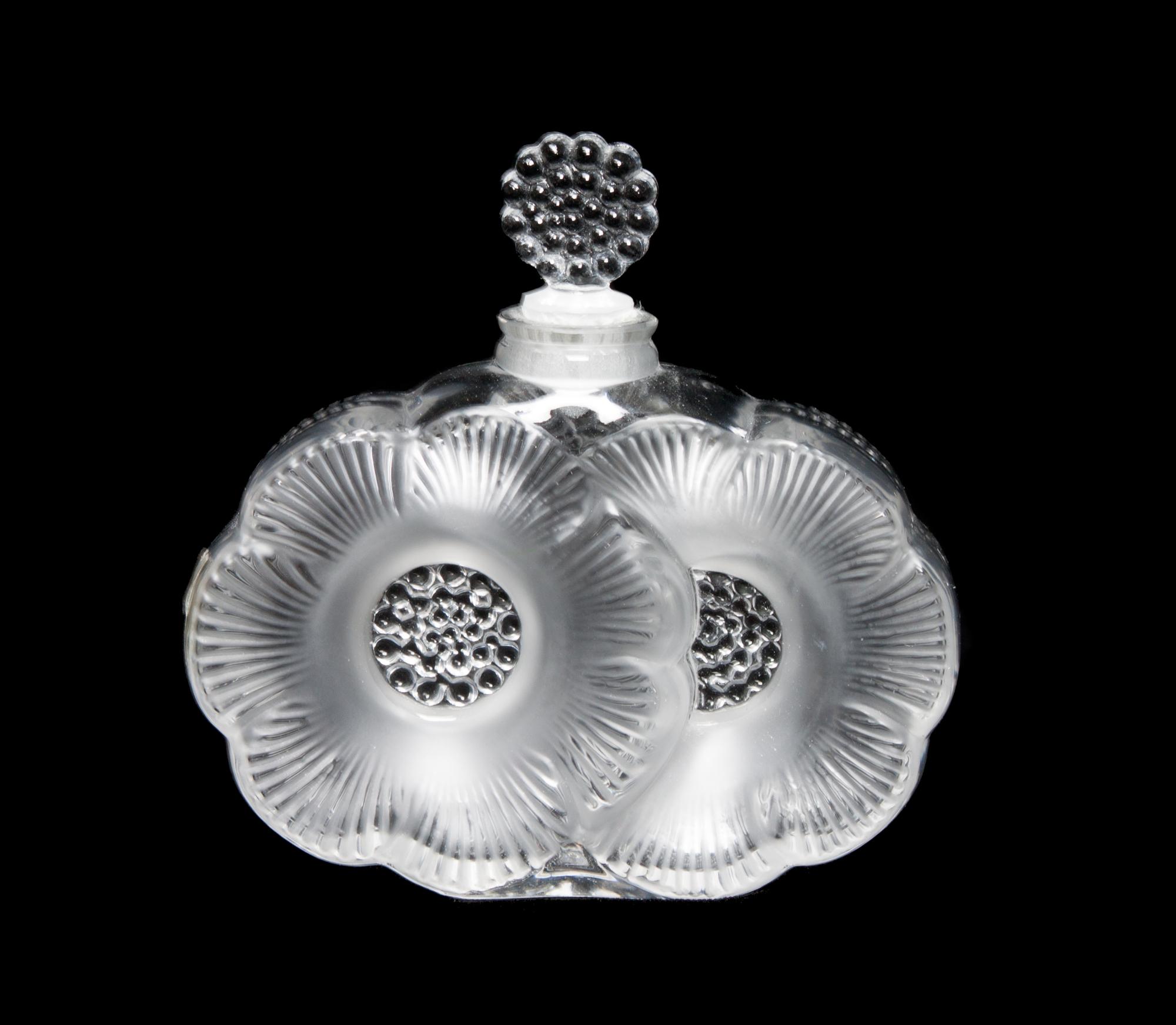 A Lalique Molded and Frosted Glass Perfume Bottle Height 3 3/4 inches.