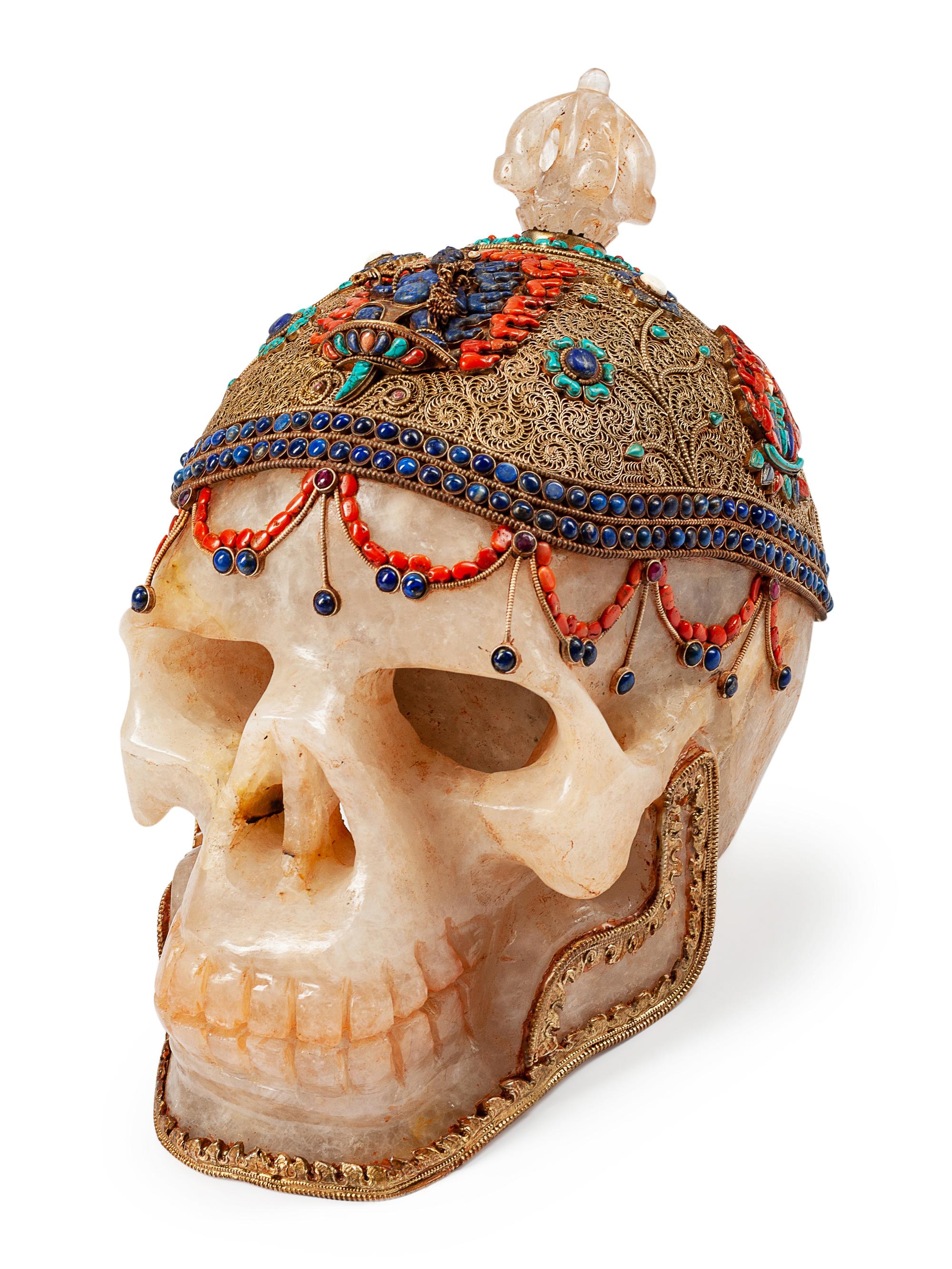 A Large Tibetan Style Silver Filigree, Lapis Lazuli, Coral and Turquoise Mounted Rock Crystal Skull