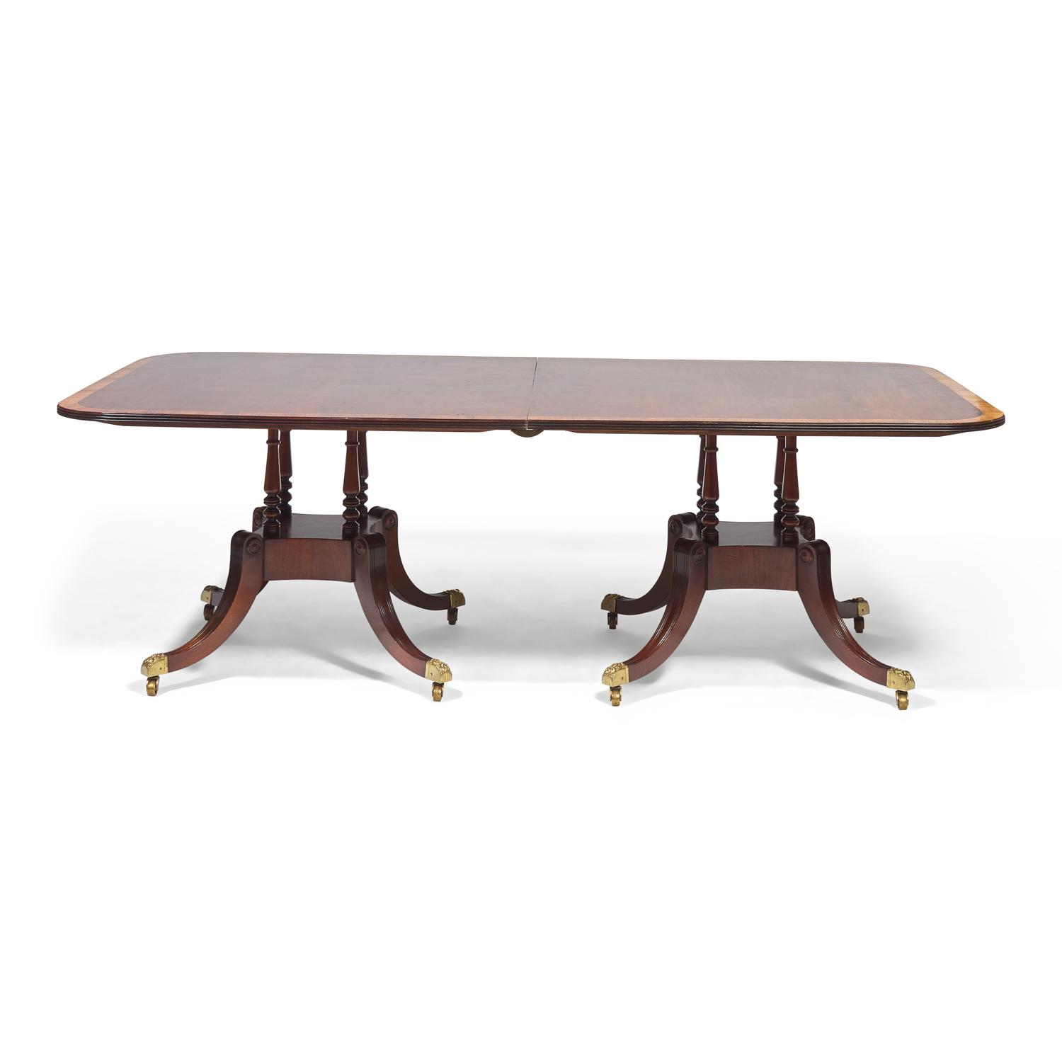 A Regency Style Mahogany and Rosewood Double Pedestal Extension Dining Table