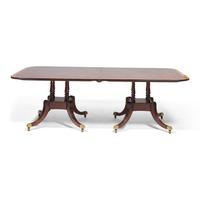 A Regency Style Mahogany and Rosewood Double Pedestal Extension Dining Table