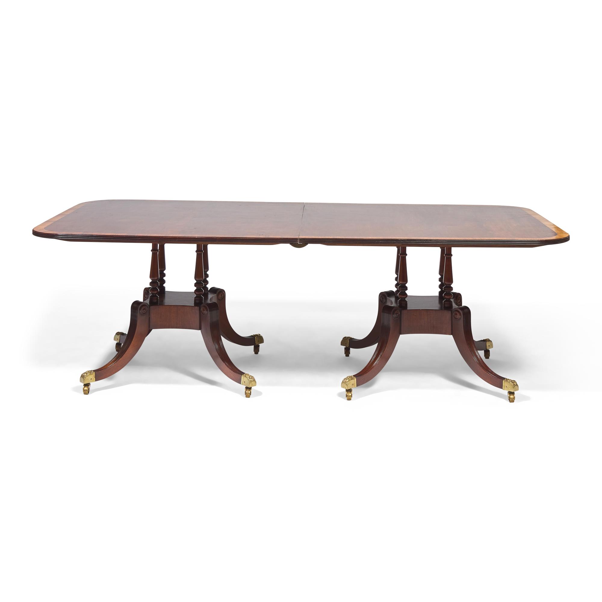 A Regency Style Mahogany and Rosewood Double Pedestal Extension Dining Table
