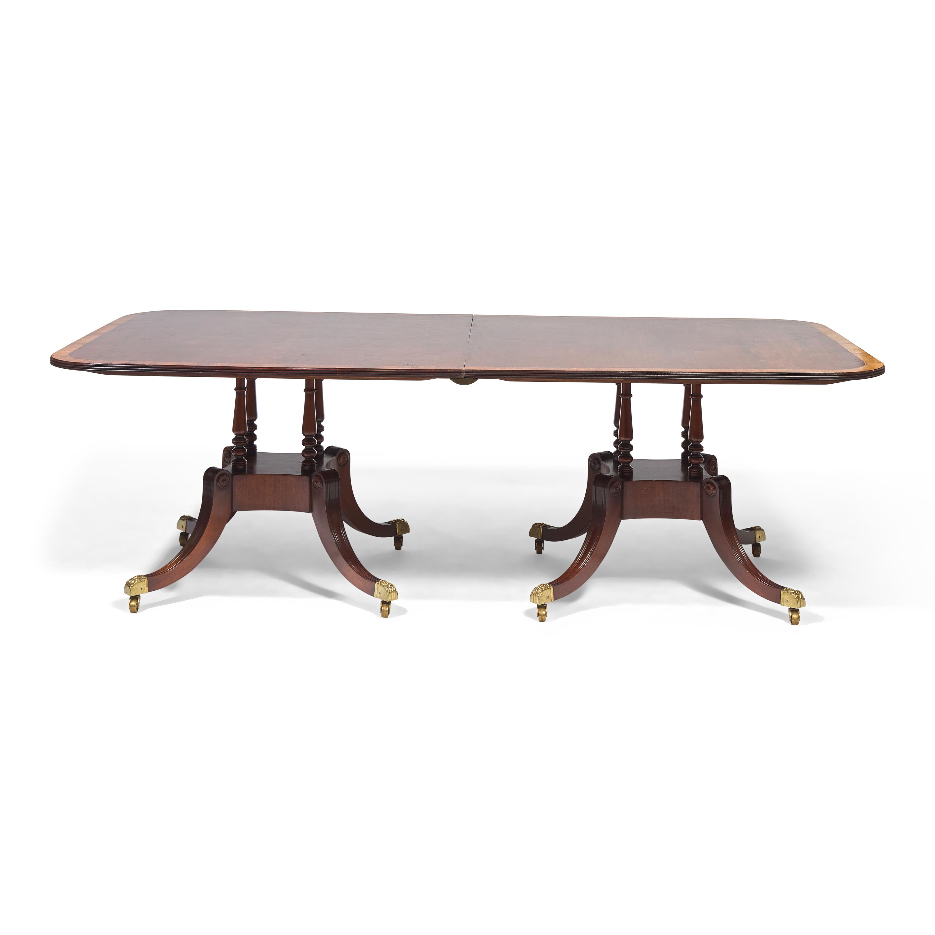 A Regency Style Mahogany and Rosewood Double Pedestal Extension Dining Table
