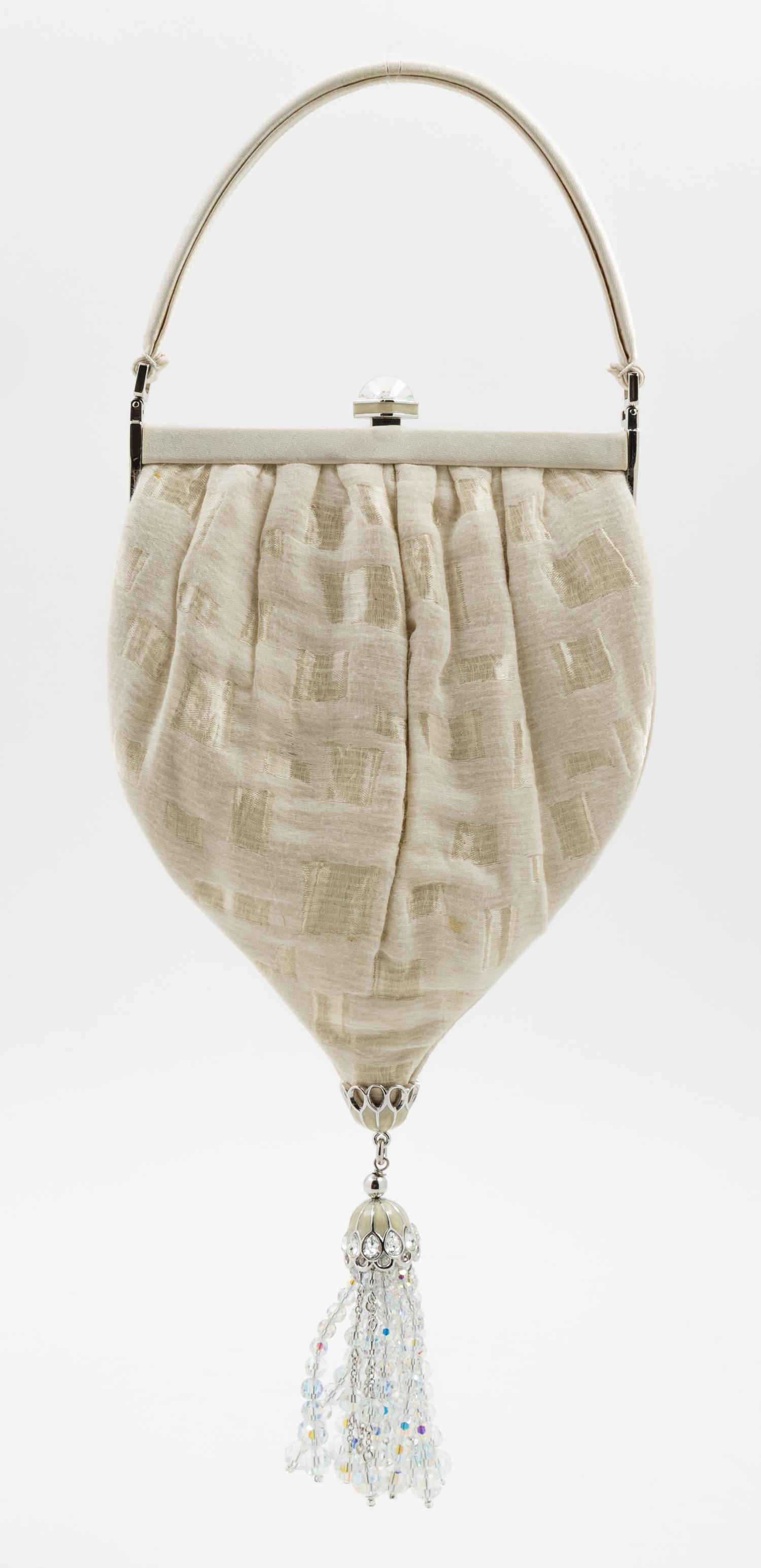 A Judith Leiber Cream Silk Textured Handbag, 5.5" x 10" x 1"; Handle drop: 3".