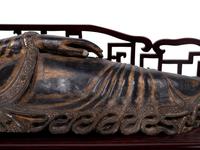 A Thai Gilt Decorated Black Lacquered Wood Figure of Reclining Buddha