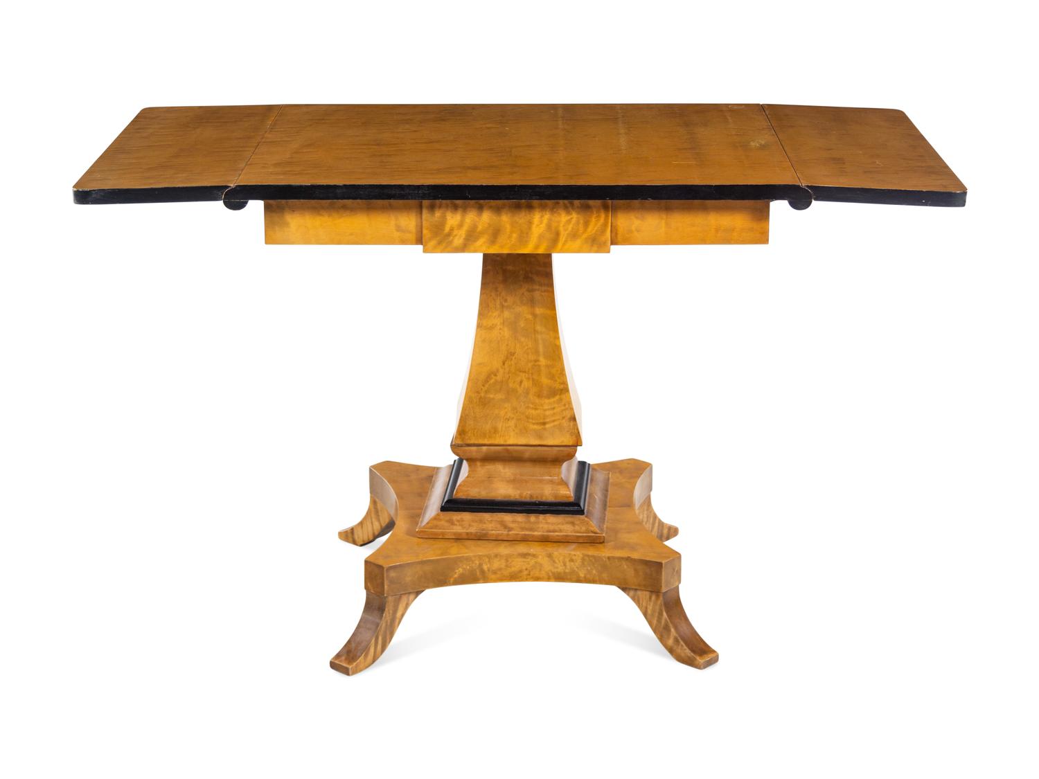 A Biedermeier Style Parcel Ebonized Satinwood Veneered Sofa Table